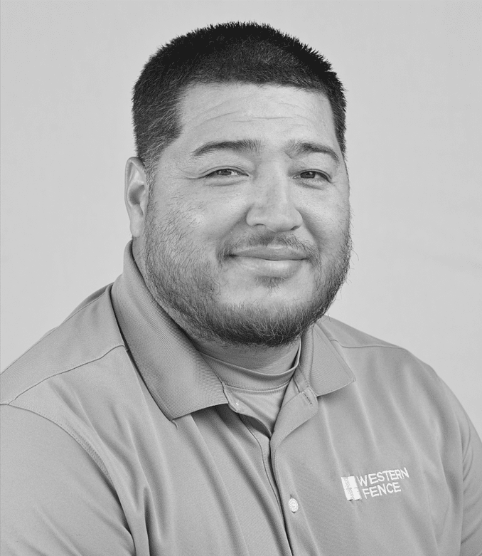 Black-and-white portrait of a smiling man with short dark hair and a trimmed beard wearing a polo shirt.